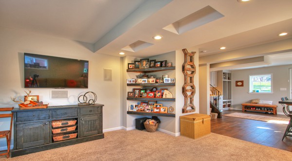 AFTER: That same view is now a family room with artful details like soffit design and reclaimed barn wood shelving.